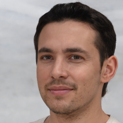 Joyful white young-adult male with short  black hair and brown eyes