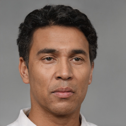 Neutral latino adult male with short  black hair and brown eyes
