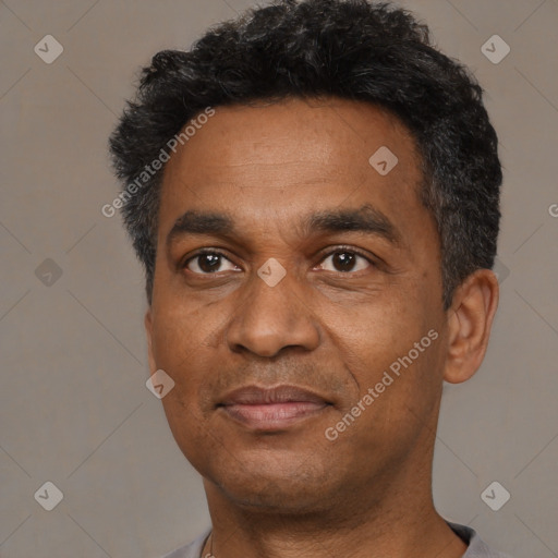 Joyful black adult male with short  black hair and brown eyes