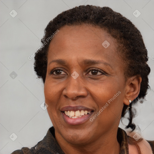 Joyful black adult female with medium  brown hair and brown eyes