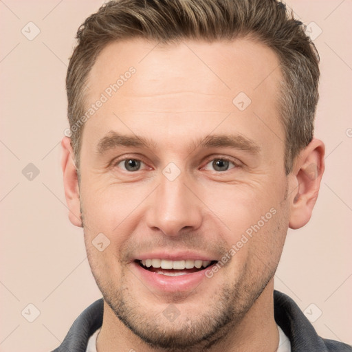 Joyful white adult male with short  brown hair and brown eyes