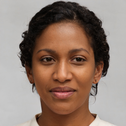 Joyful black young-adult female with medium  brown hair and brown eyes