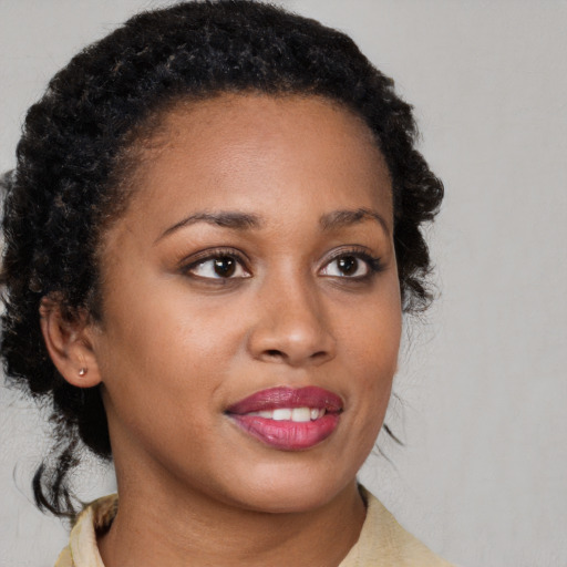 Joyful black young-adult female with medium  brown hair and brown eyes