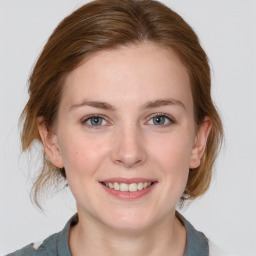 Joyful white young-adult female with medium  brown hair and blue eyes