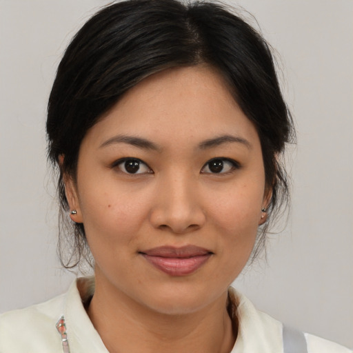 Joyful asian young-adult female with medium  brown hair and brown eyes