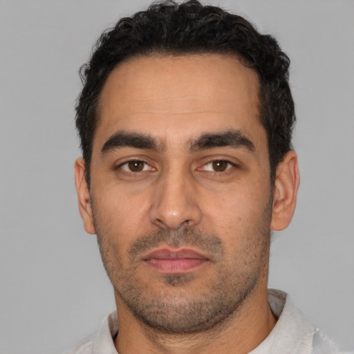 Neutral latino young-adult male with short  black hair and brown eyes