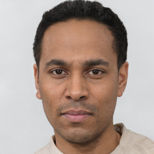 Neutral latino young-adult male with short  black hair and brown eyes