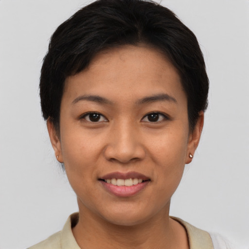 Joyful asian young-adult female with short  black hair and brown eyes