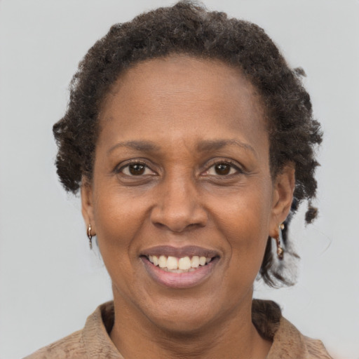 Joyful black adult female with short  brown hair and brown eyes