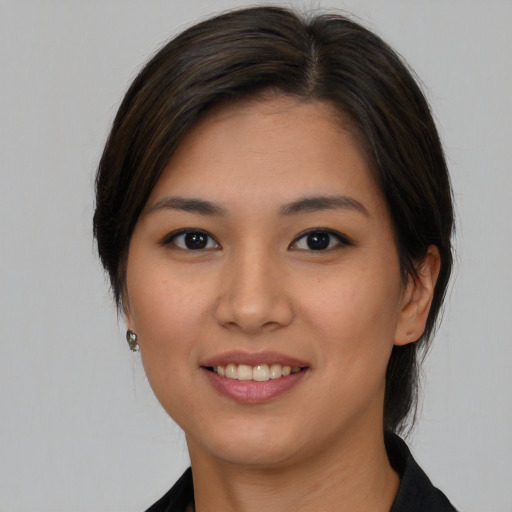 Joyful asian young-adult female with medium  brown hair and brown eyes
