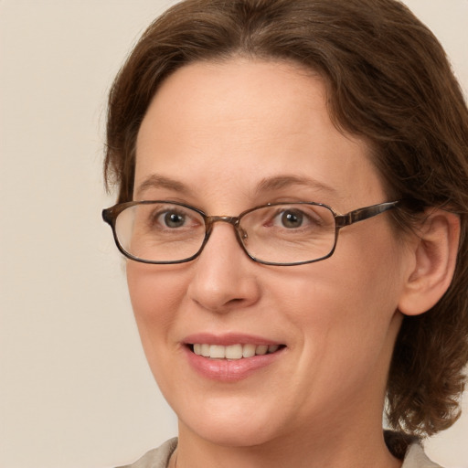 Joyful white adult female with medium  brown hair and grey eyes