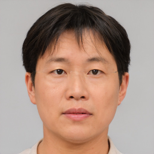 Neutral asian adult male with short  brown hair and brown eyes