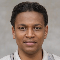 Joyful latino young-adult male with short  brown hair and brown eyes