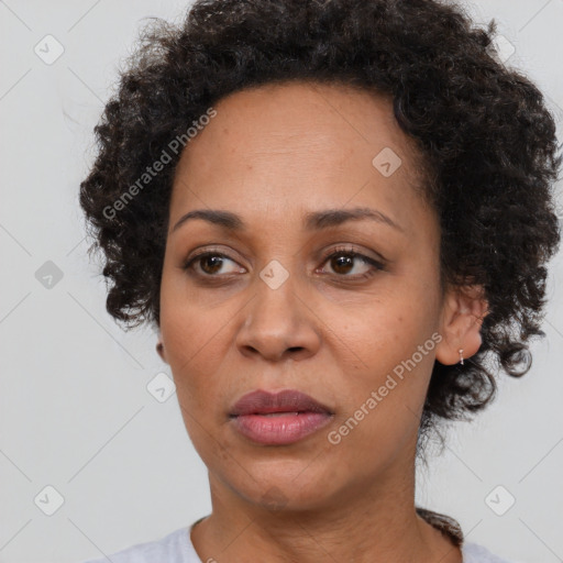 Joyful black adult female with short  brown hair and brown eyes