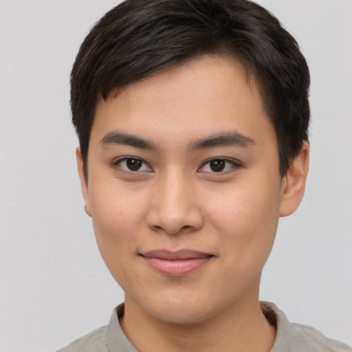 Joyful asian young-adult male with short  brown hair and brown eyes