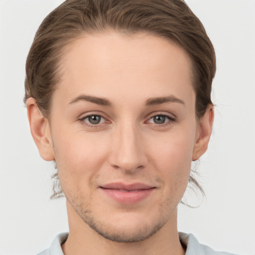 Joyful white young-adult female with short  brown hair and grey eyes