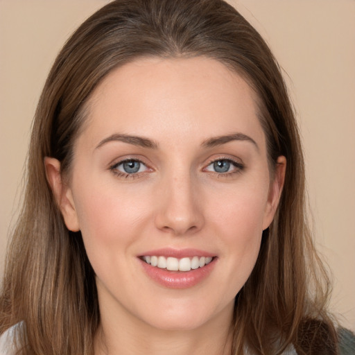 Joyful white young-adult female with long  brown hair and grey eyes