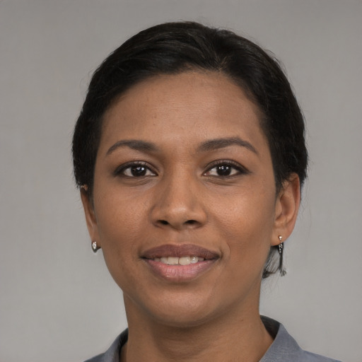 Joyful black young-adult female with medium  black hair and brown eyes