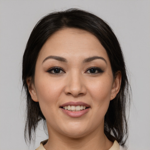 Joyful asian young-adult female with medium  brown hair and brown eyes