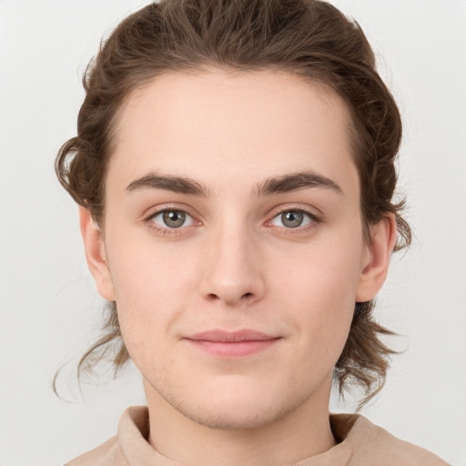 Joyful white young-adult male with medium  brown hair and grey eyes