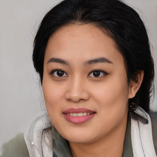 Joyful asian young-adult female with long  brown hair and brown eyes