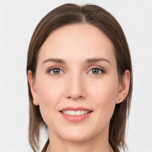 Joyful white young-adult female with long  brown hair and grey eyes