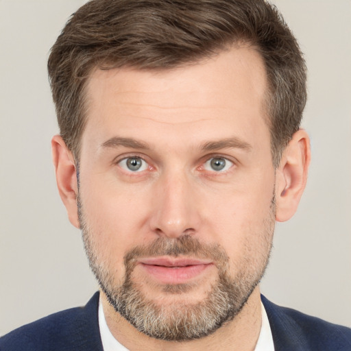 Joyful white adult male with short  brown hair and grey eyes