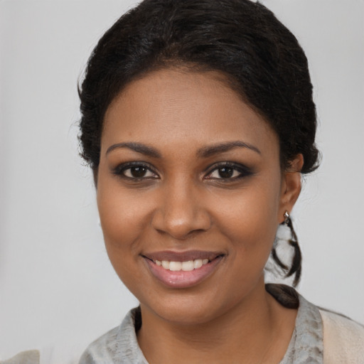 Joyful black young-adult female with medium  brown hair and brown eyes