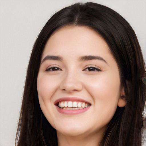 Joyful white young-adult female with long  black hair and brown eyes