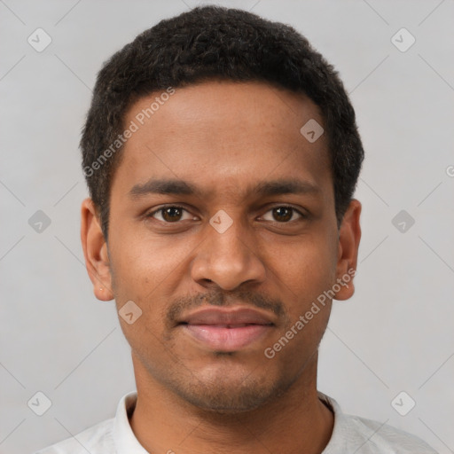 Joyful black young-adult male with short  brown hair and brown eyes
