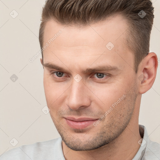 Joyful white young-adult male with short  brown hair and brown eyes