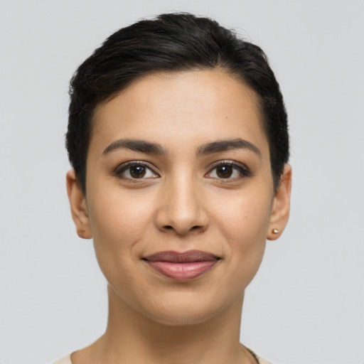 Joyful latino young-adult female with short  black hair and brown eyes