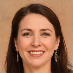 Joyful white adult female with long  brown hair and grey eyes