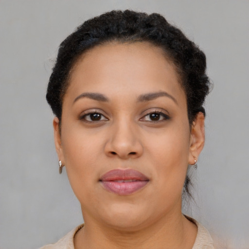 Joyful black young-adult female with short  brown hair and brown eyes