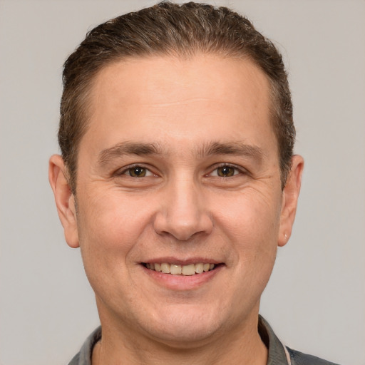 Joyful white adult male with short  brown hair and brown eyes