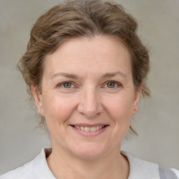 Joyful white adult female with medium  brown hair and brown eyes