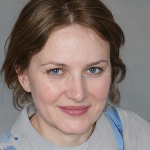 Joyful white adult female with medium  brown hair and blue eyes