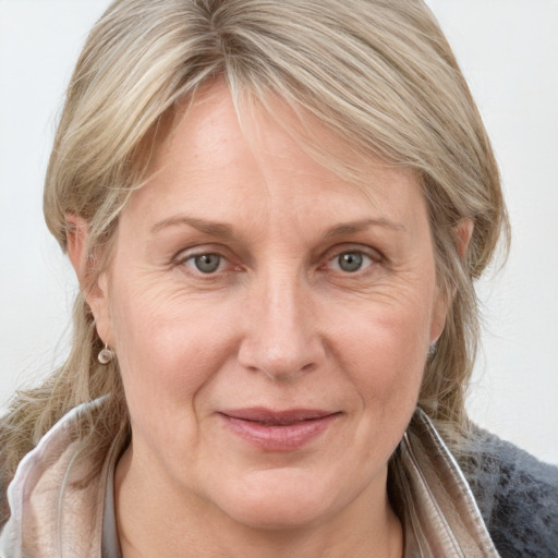 Joyful white adult female with medium  brown hair and grey eyes