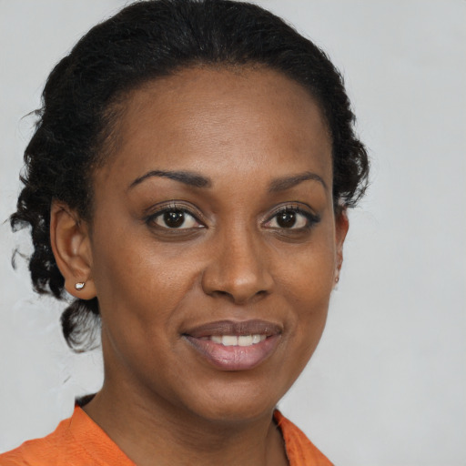 Joyful black young-adult female with medium  brown hair and brown eyes