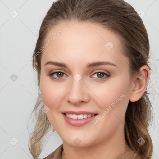 Joyful white young-adult female with long  brown hair and grey eyes