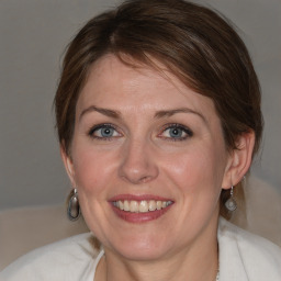 Joyful white young-adult female with medium  brown hair and blue eyes