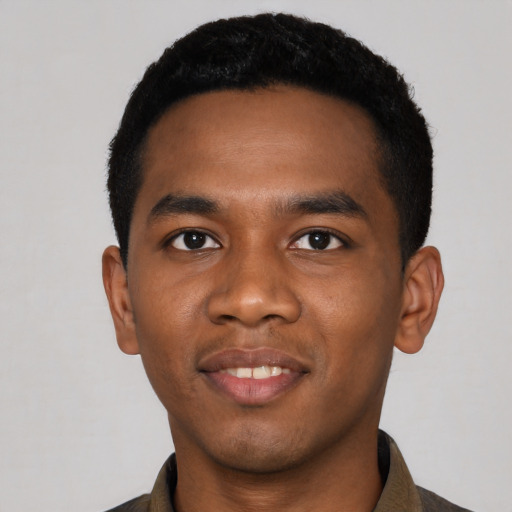 Joyful black young-adult male with short  black hair and brown eyes