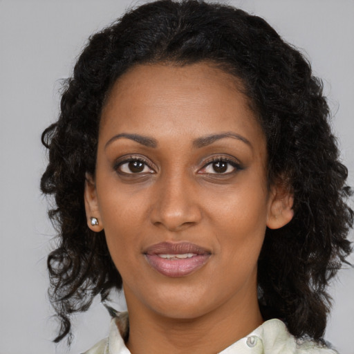 Joyful black young-adult female with medium  brown hair and brown eyes