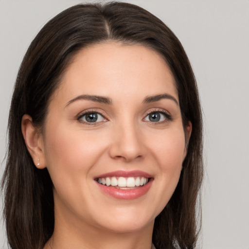 Joyful white young-adult female with medium  brown hair and brown eyes