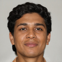 Joyful latino adult male with short  brown hair and brown eyes