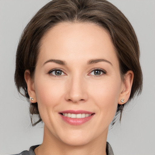 Joyful white young-adult female with medium  brown hair and brown eyes