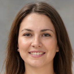 Joyful white young-adult female with long  brown hair and grey eyes