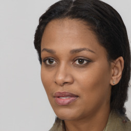 Joyful black young-adult female with long  brown hair and brown eyes