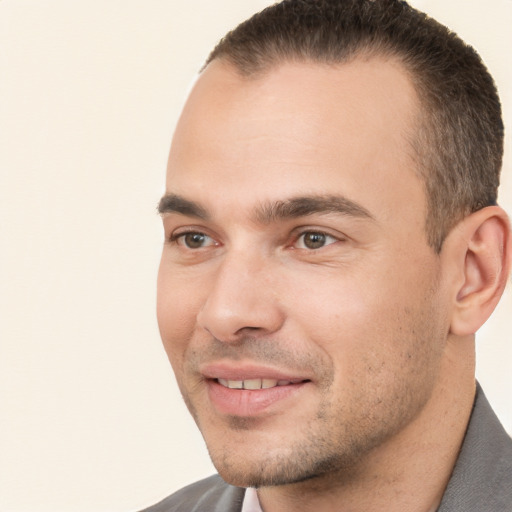 Joyful white young-adult male with short  brown hair and brown eyes