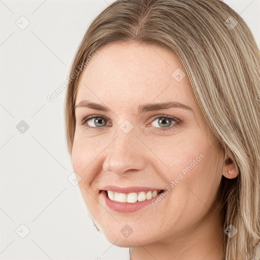 Joyful white young-adult female with long  brown hair and blue eyes